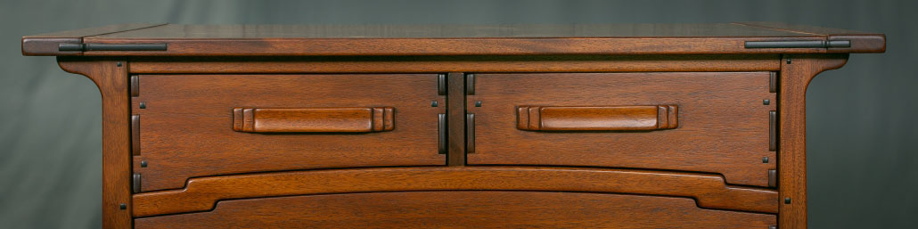 Greene and Greene Style pulls on drawers divided by a cloud lift